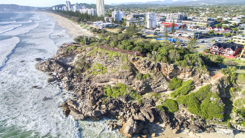 Aerial view of Miami Headland lookout and beach as the sun hits the shoreline. Gold Coast, Australia