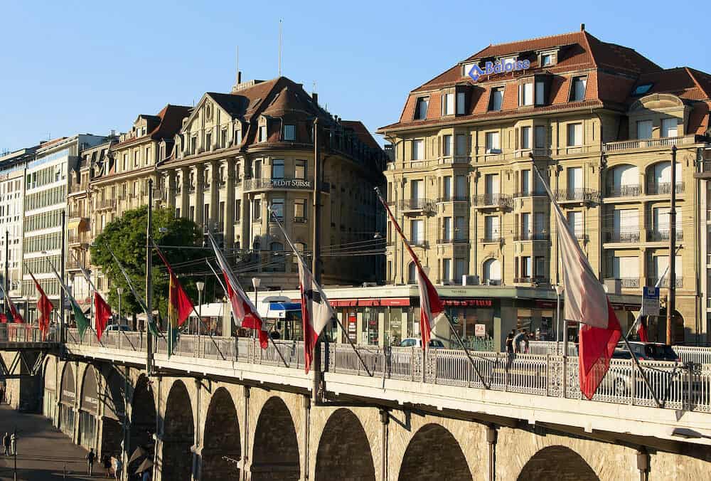 Lausanne Switzerland - Le Flon district and Grand pont bridge with flags in Lausanne Switzerland. People on the background