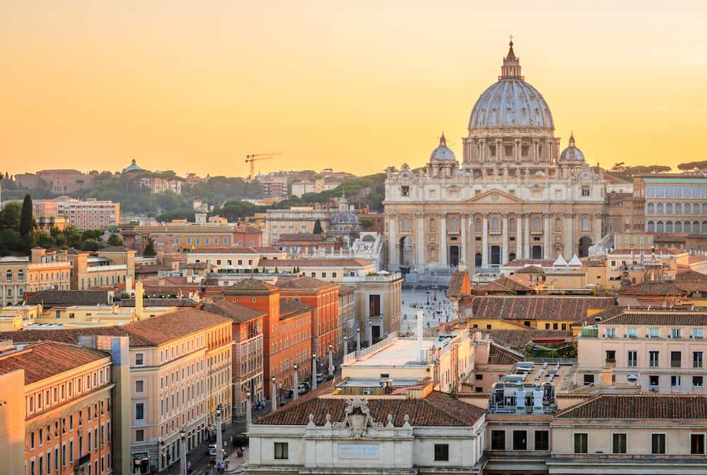 Vatican city at sunset in Rome, Italy. On the background the St. Peter Basilica in Vatican. Rome famous landmark. St Peter in Vatican city is the most important church of the world.