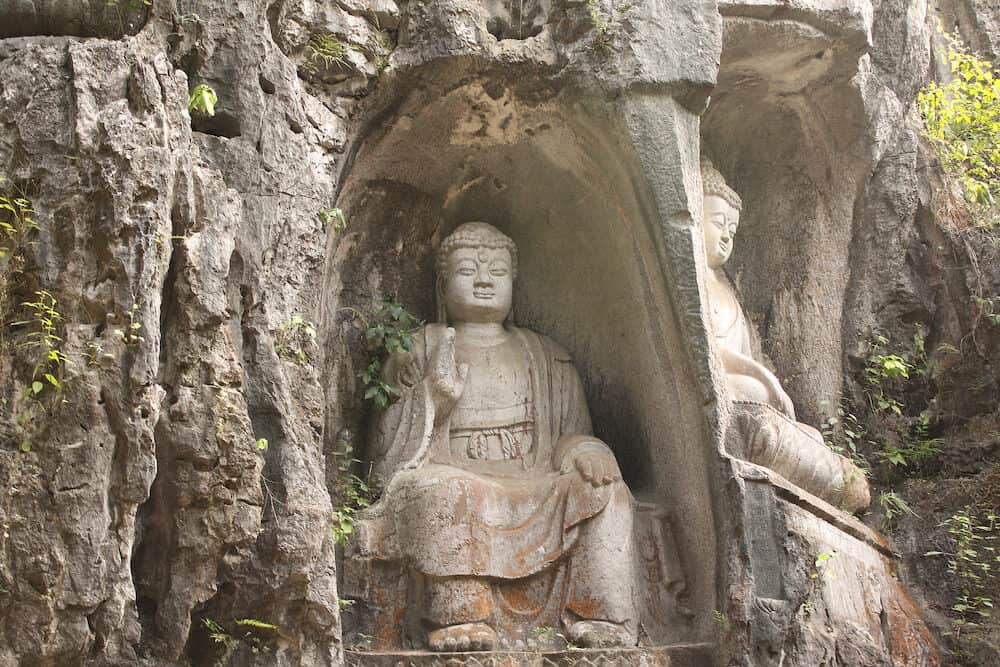 Ancient stone statue of Buddha in cave, park near to Big Wild Goose Pagoda, Xian, Shaanxi province, China