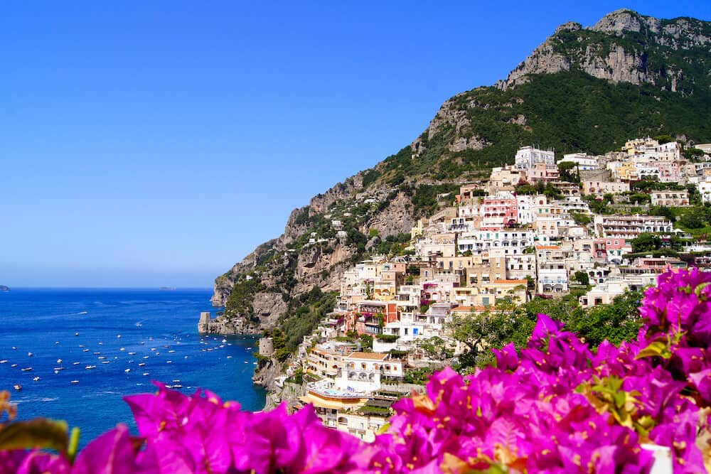 Panoramic view of Positano on the Amalfi Coast of Italy with beautiful flowers in the foreground