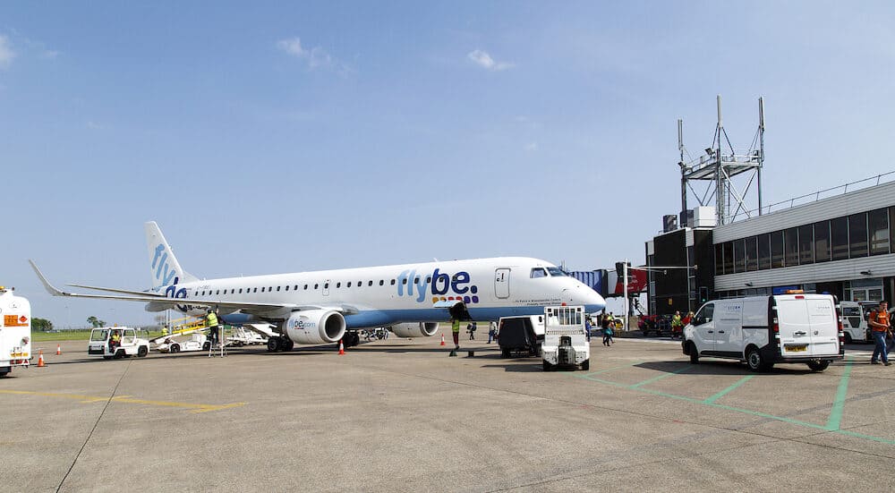 Cardiff, UK A landed aircraft is being serviced by the ground crew while passengers still desembark. Flybe is the largest independent regional airline in Europe and is based in Exeter.