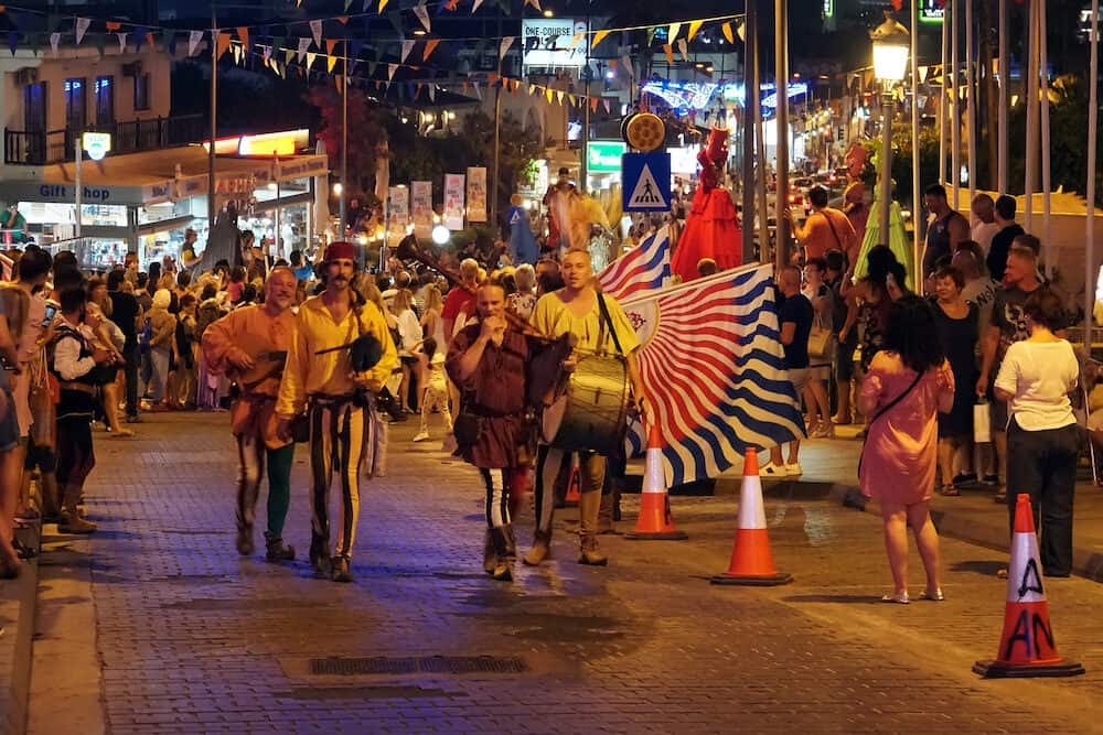 Annual festival of Medieval cultures of Europe. The procession of the column in the carnival historical costumes of the city at night. Cyprus, Ayia NAPA. 