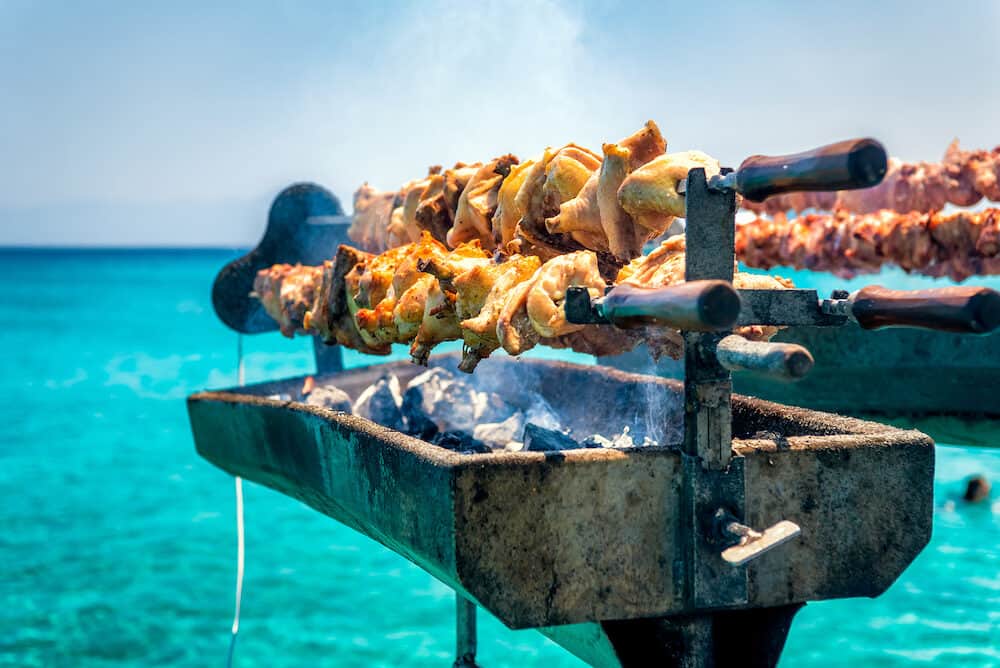 Cooking fresh Cypriot souvla on the sea