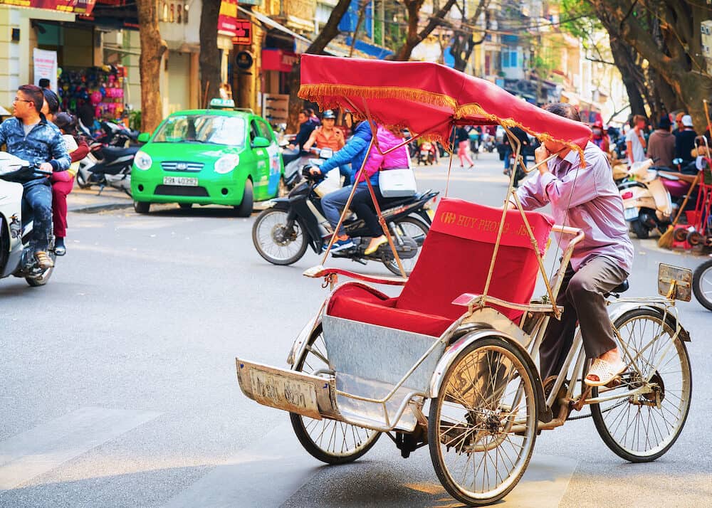 Hanoi, Vietnam - Cycle rickshaw on busy street in Hanoi, Vietnam