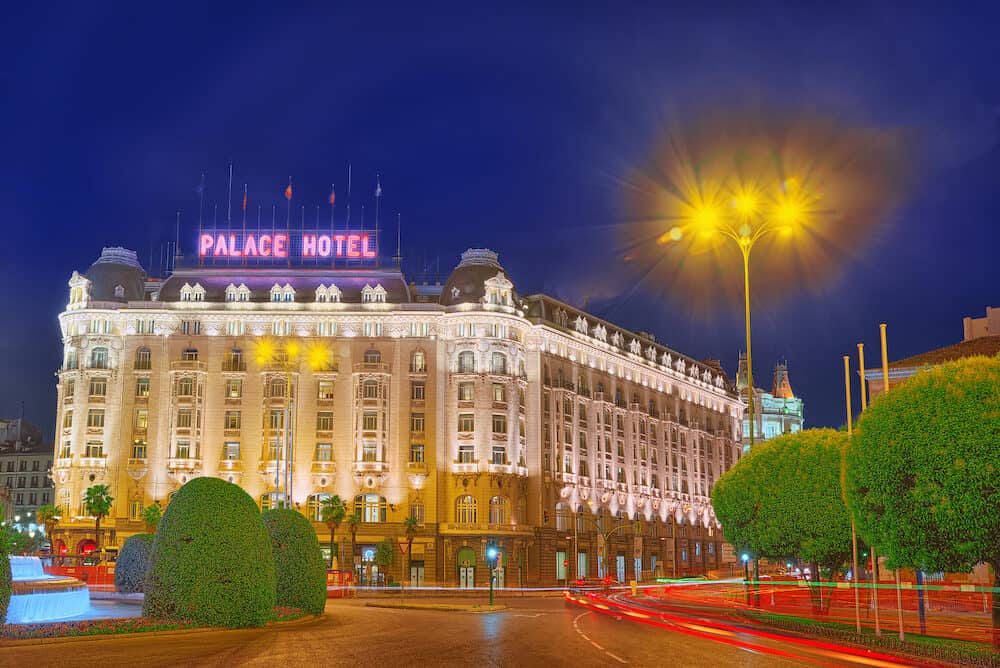 Madrid Spain - : Neptune Fountain (Fuente de Neptuno) and The Westin Palace Hotel on Square of the Loyalty (Plaza de la Lealtad) at night.