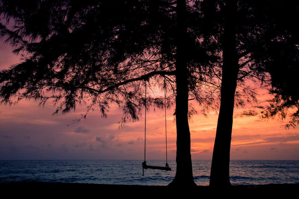 The silhouette of a swing background image. At Mai Khao Beach, Phuket, Thailand