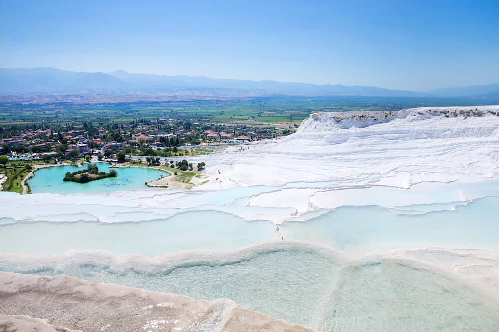 Pamukkale, Turkey - Tourists on Pamukkale Travertine pools and terraces. Pamukkale is famous UNESCO world heritage site in Turkey