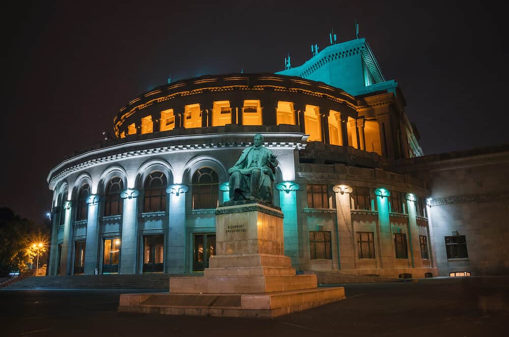 Yerevan Armenia - National Academic Theatre of Opera and Ballet named after Alexander Spendiaryan of Armenia illuminated at night. Composer Spendiaryan statue.