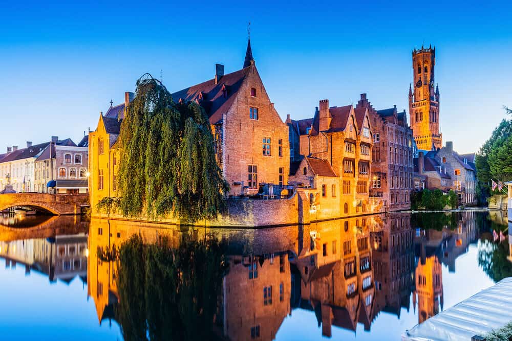 Bruges, Belgium. The Rozenhoedkaai canal in Bruges with the Belfry in the background.