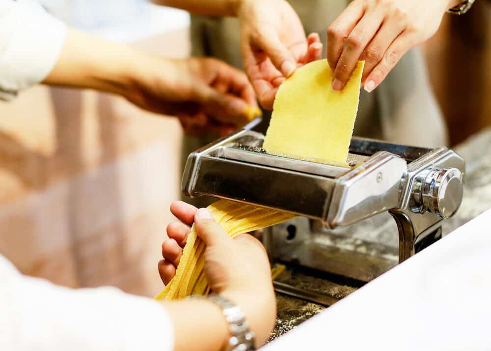 Chef making pasta with a machine, home made fresh pasta