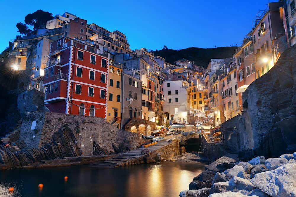 Riomaggiore waterfront view with buildings in Cinque Terre at night, Italy.