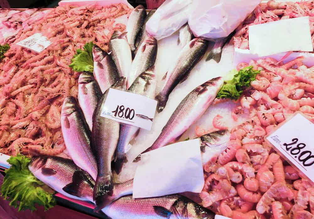 Venetian fish market - fish and prawns. The Rialto fish market is located alongside the Grand Canal near the Rialto Bridge - Venice, Italy
