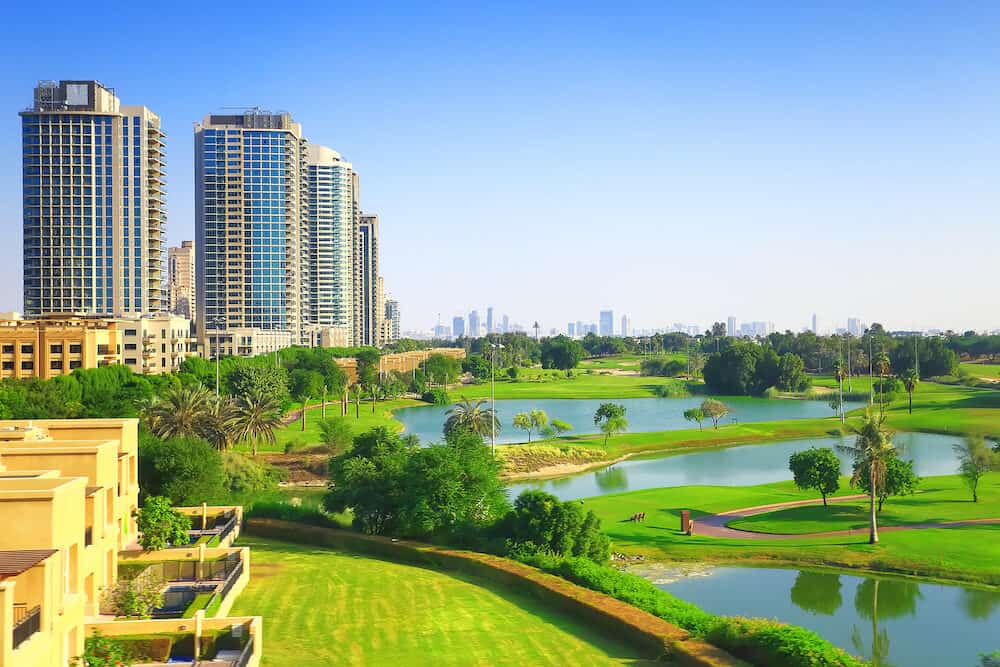 Dubai luxury residential district with golf club on a sunny day. Background for real estate themes.
