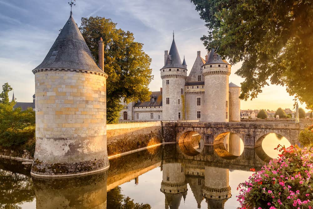 Castle or chateau of Sully-sur-Loire at sunset, France. This old castle is a famous landmark in France. Beautiful sunny view of the French castle on the water. Fairytale medieval castle in summer.