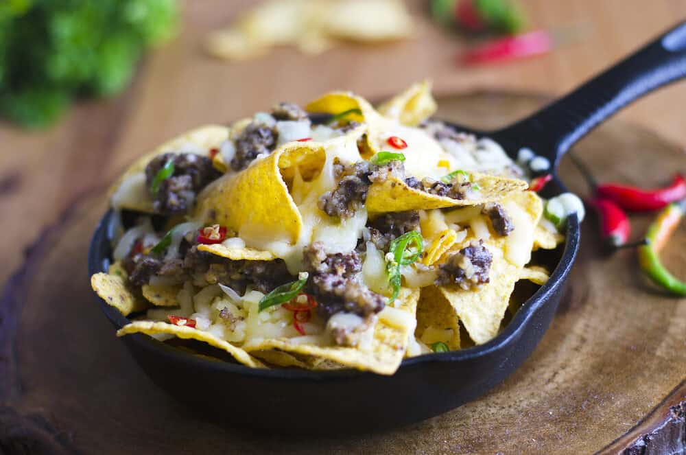 Nachos with haggis melted cheese and chilli peppers