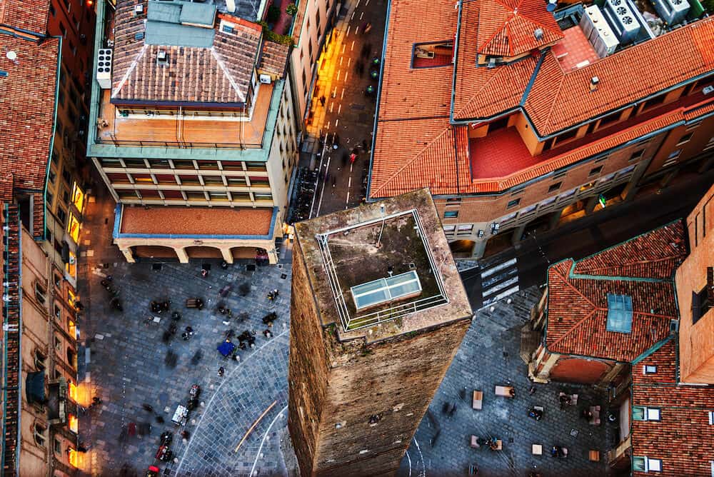 Bologna, Italy. Aerial view of Bologna, Italy with one tower. City life in the historical city center with people and old buildings - cafes, bars, restaurants