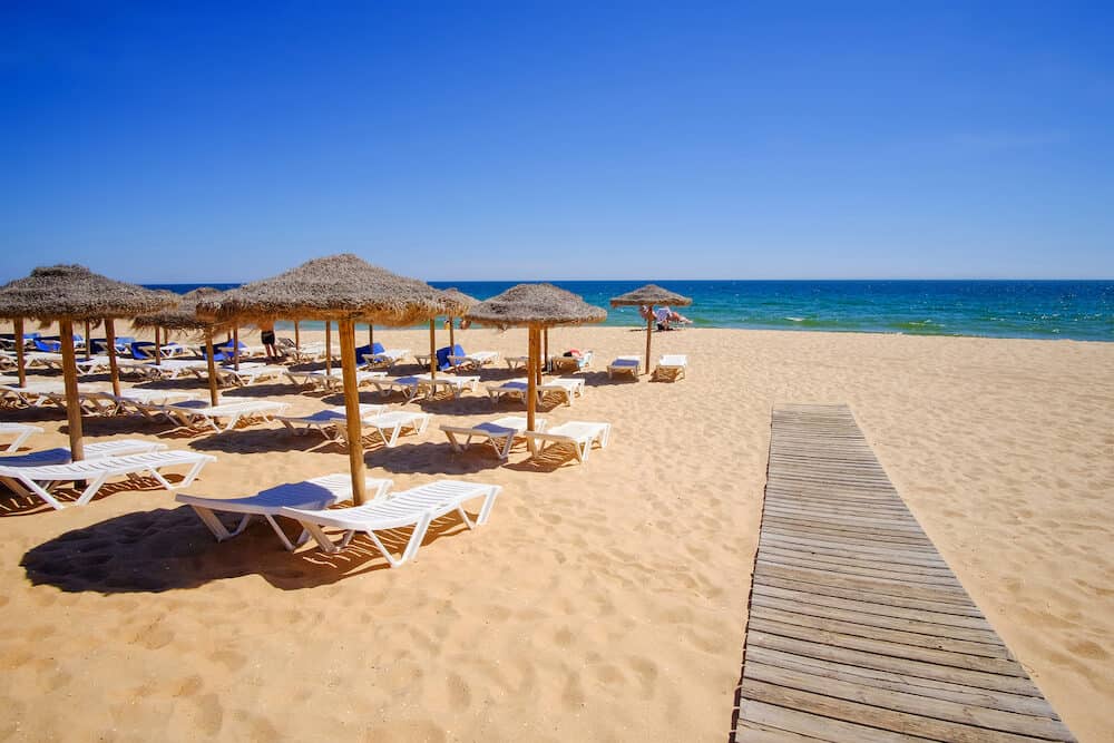 View on the beautiful beach Praia da Falesia - Praia da Rocha Baixinha Nascente with beautiful red rocks and golden sand. Region Faro, Algarve. Vacation in Portugal.