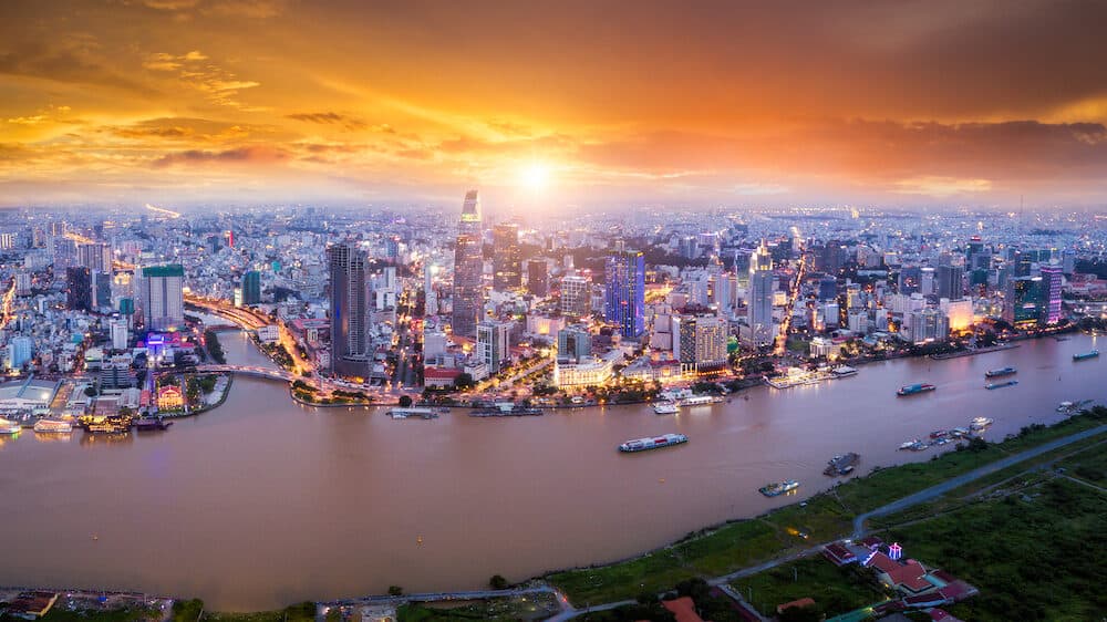 Aerial view of Ho Chi Minh City skyline and skyscrapers in center of heart business at Ho Chi Minh City downtown. Panorama of cityscape on Saigon river in Ho Chi Minh City at Vietnam at sunset scene