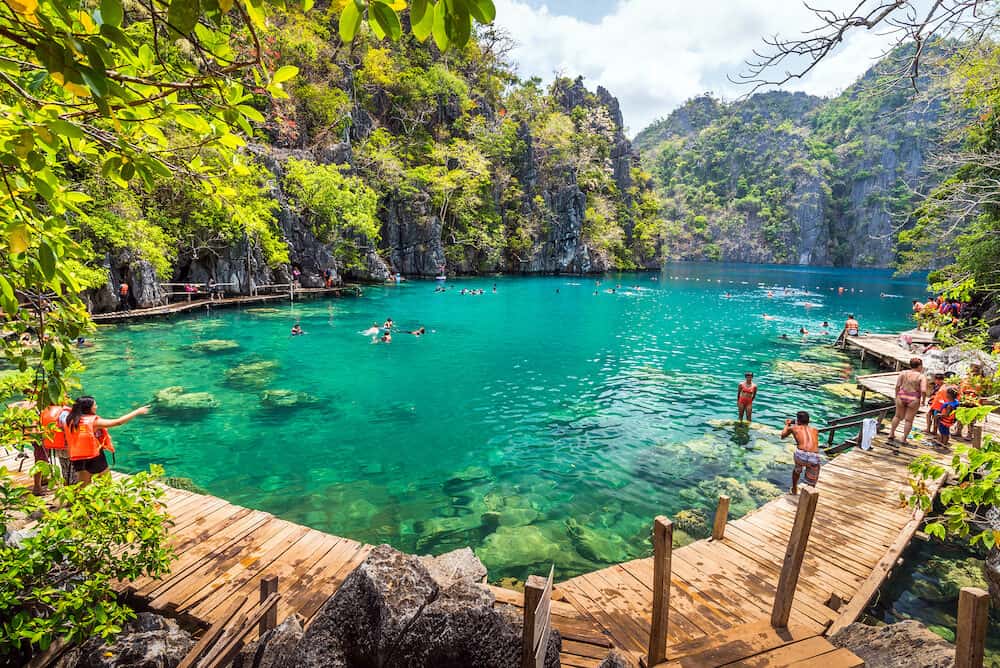 Palawan, Philippines - People tourists swimming at Kayangan Lake in Coron Island, Palawan, The Philippines.