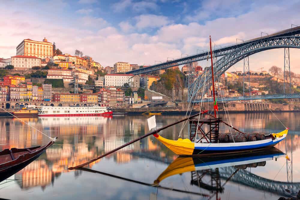 Porto, Portugal. Cityscape image of Porto, Portugal with reflection of the city in the Douro River during sunrise.