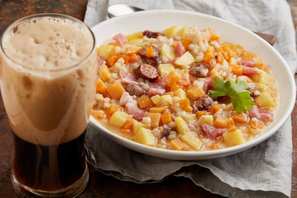 Traditional Irish dish Dublin coddle with sausages and beer on a table