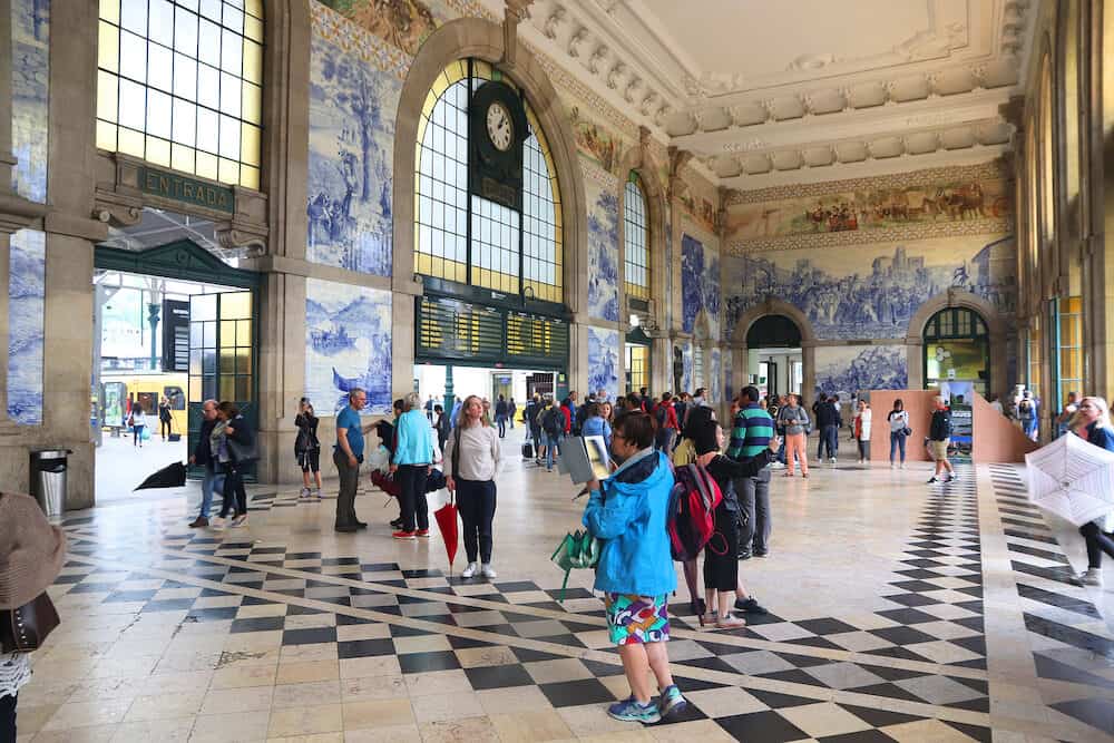 PORTO, PORTUGAL - People visit Sao Bento Station in Porto, Portugal. The railway station dates back to 1864 and is one of main train stations in Portugal.