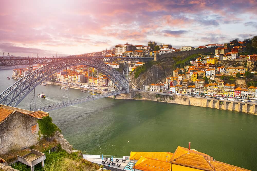 Porto Cityscape on the Douro River and Dom Luis I Bridge at Sunset. Horizontal image Composition
