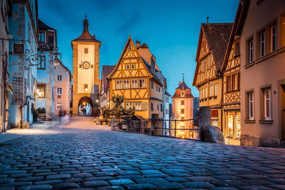 Classic view of the medieval town of Rothenburg ob der Tauber illuminated in beautiful evening twilight during blue hour at dusk, Bavaria, Germany