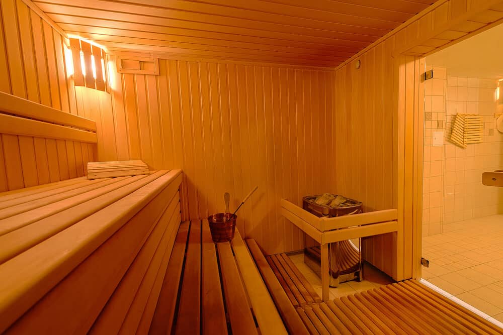 Sauna room interior as background, spa room. Relax in a hot sauna, Finland-style classic wooden sauna interior in public building, hotel. Small home Finnish wooden sauna