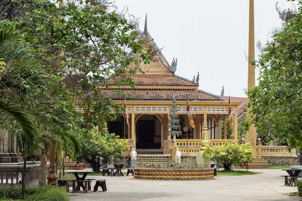 Buddhist architecture in Wat Damnak pagoda, Siem Reap, Cambodia. Traditional thai or khmer pagoda. Buddhist shrine with ornament. Roof gable ending. Buddhist wat and park. Cambodian sightseeing travel