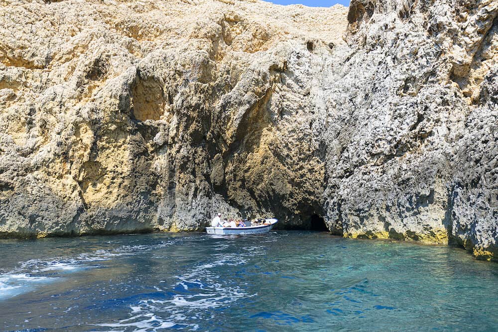 BISEVO ISLAND, CROATIA Blue Cave carved in the limestone by the Adriatic Sea, tourists sailing by boat to the grotto