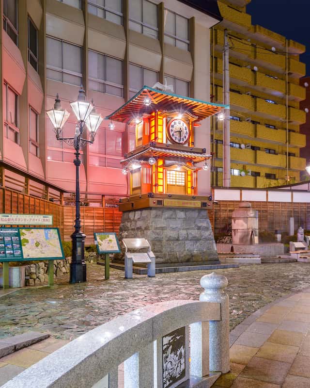 MATSUYAMA, The Botchan Karakuri Clock at night in Hojoen Square. The clock was erected in 1994 for the Centennial of the nearby Dogo Onsen bath house.