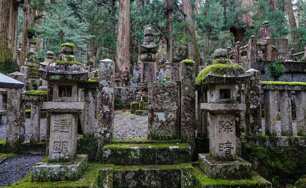 Koyasan, Japan - Ancient graves at forest in Mount Koya, Japan. Koyasan is primarily known as the world headquarters of the Shingon sect of Buddhism.