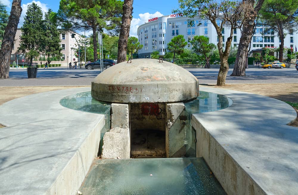 TIRANA ALBANIA - Monument-bunker TR-V-76851 on background - hotel "Rogner" Tirana Albania