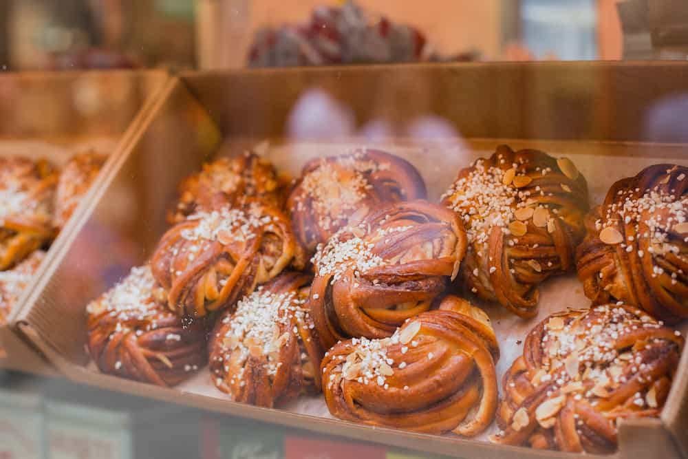 Traditional Swedish cinnamon buns. A very popular snack throughout Scandinavia known as Fika. Closeup of delicious freshly baked cinnamon bun in showcase