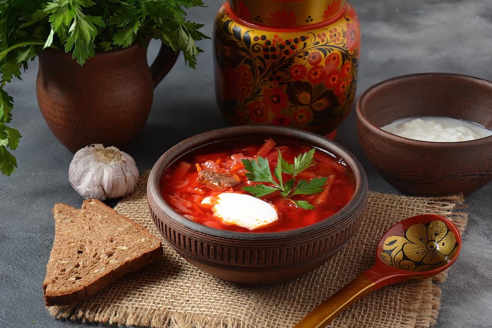 Traditional Ukrainian Russian borscht . Bowl of red beet root soup borsch with white cream . Beet Root delicious soup . Traditional Ukrainian food cuisine