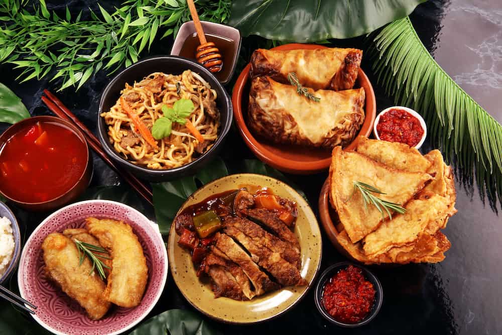 Assorted Chinese food set. Chinese noodles, fried rice, peking duck, dim sum, spring rolls. Famous Chinese cuisine dishes on table. Chinese restaurant concept. Asian style banquet