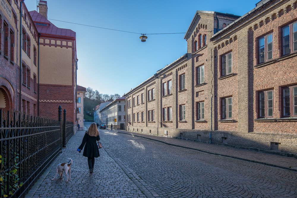 GOTHENBURG, SWEDEN Woman walks a dog in Haga, Gothenburg. Haga is a historic residential area, which has become fashionable and popular among tourists.