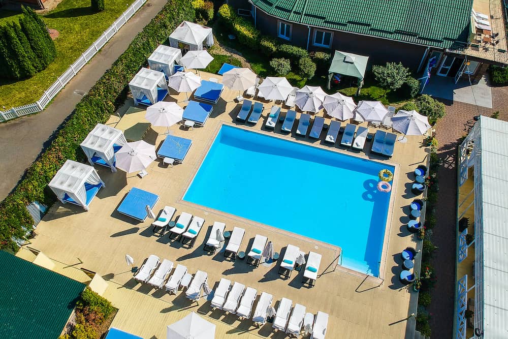 KIEV, UKRAINE - hotel and restaurant complex Seasons SPA. blue swimming pool with sunbeds and bungalows