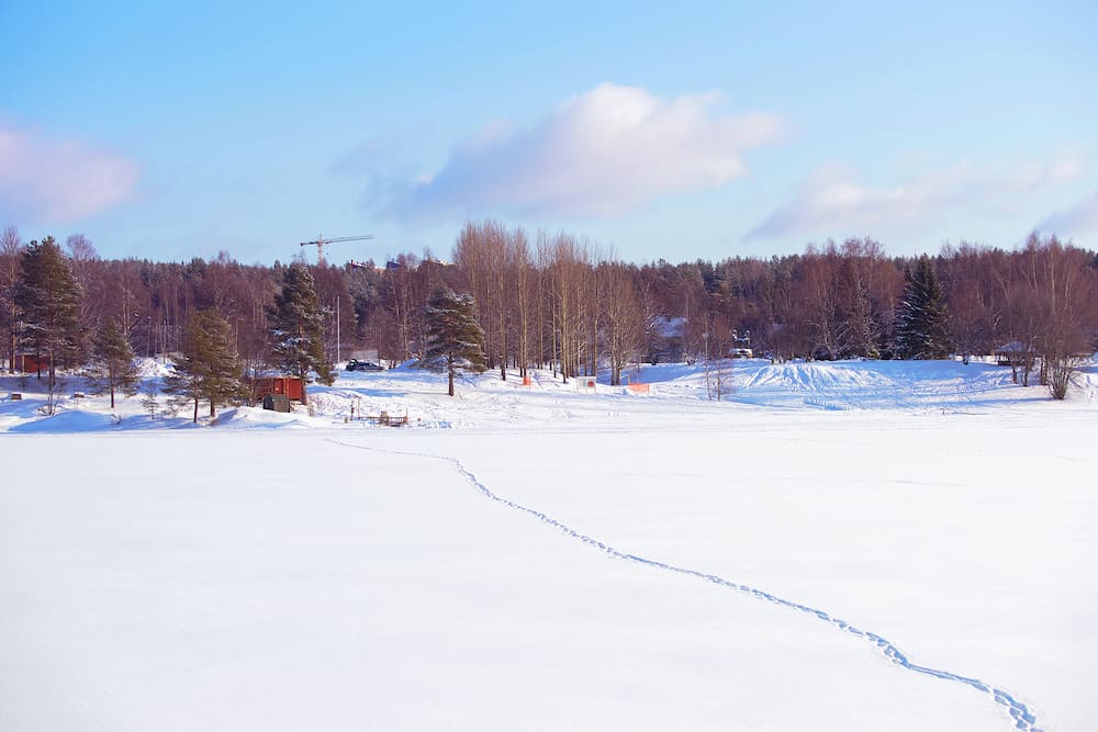 Frozen river with footprints on the snow in winter Rovaniemi Lapland Finland