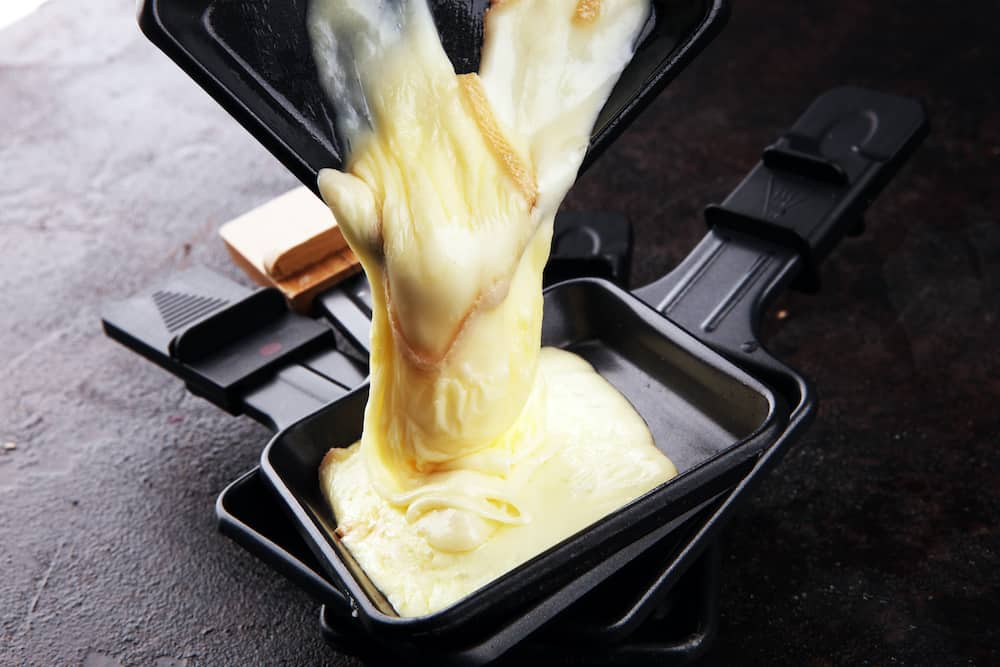 raclette cheese melted served in individual skillets. Very delicious swiss raclette