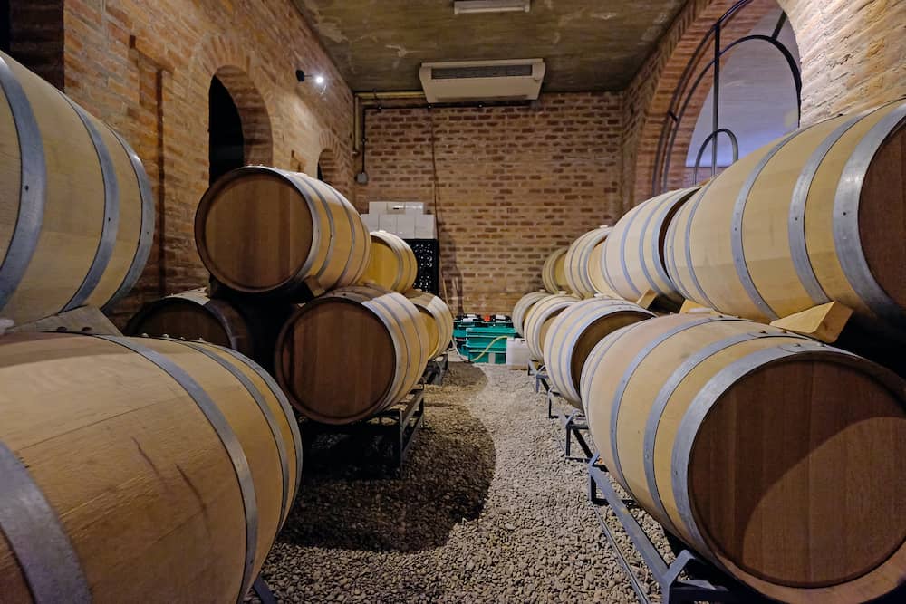 Oak wine barrels stacked in the cellar of a Malbec winery factory in San Juan, Argentina, South America, also seen in Mendoza