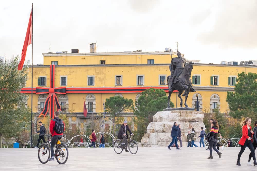 Tirana, Albania. monument to Skanderbeg in Scanderbeg Square in the center of Tirana, building decorated with national colors for independance day