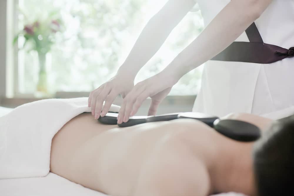 Woman Receiving Hot Stone Massage