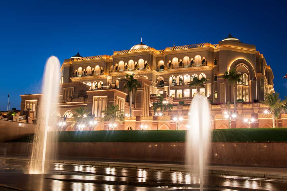 Abu Dhabi, United Arab Emirates - Emirates palace in Abu dhabi reflected on the ground level fountain at blue hour