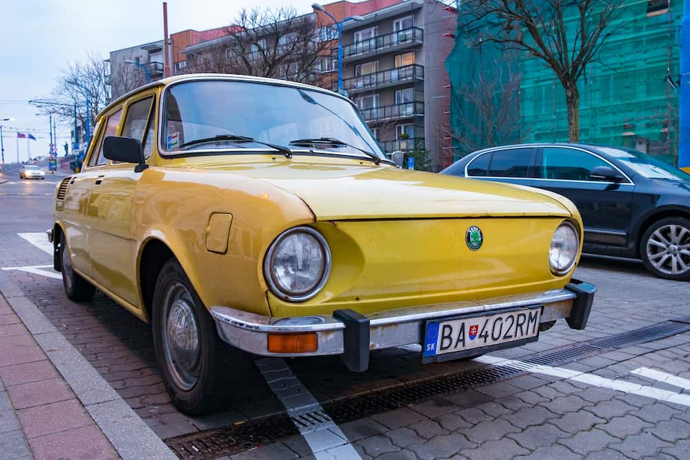 Bratislava, Slovakia - Classic vintage car yellow Skoda parked in city.