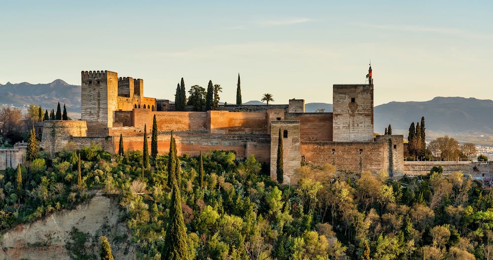 View of Alhambra Palace in Granada, Spain with Sierra Nevada mountains at the background