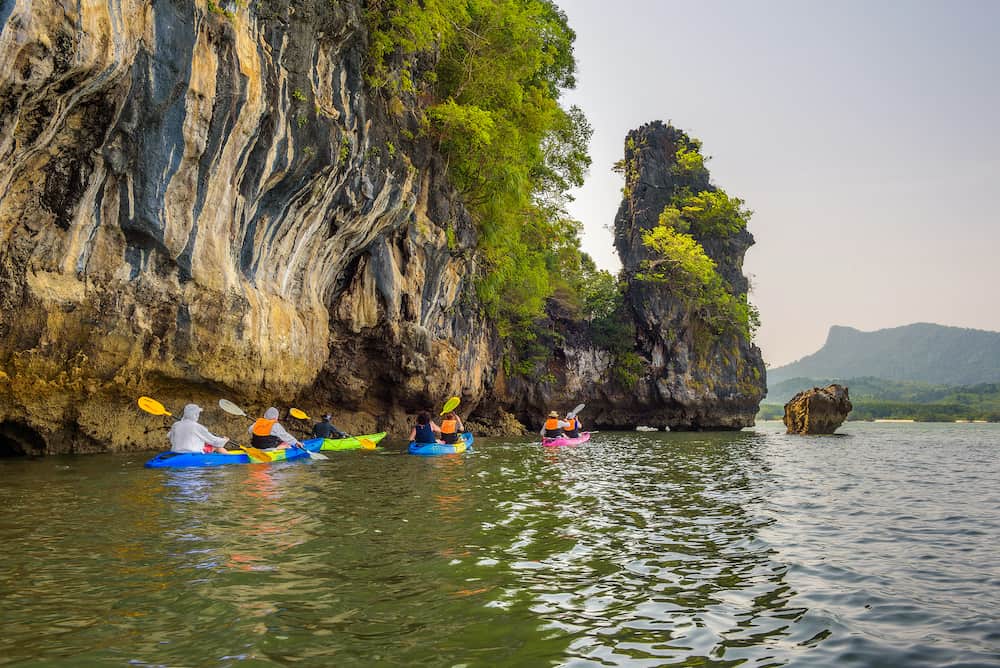 Phang Nga Bay, Thailand Group of tourists kayaking into mangrove jungle of Krabi in Thailand