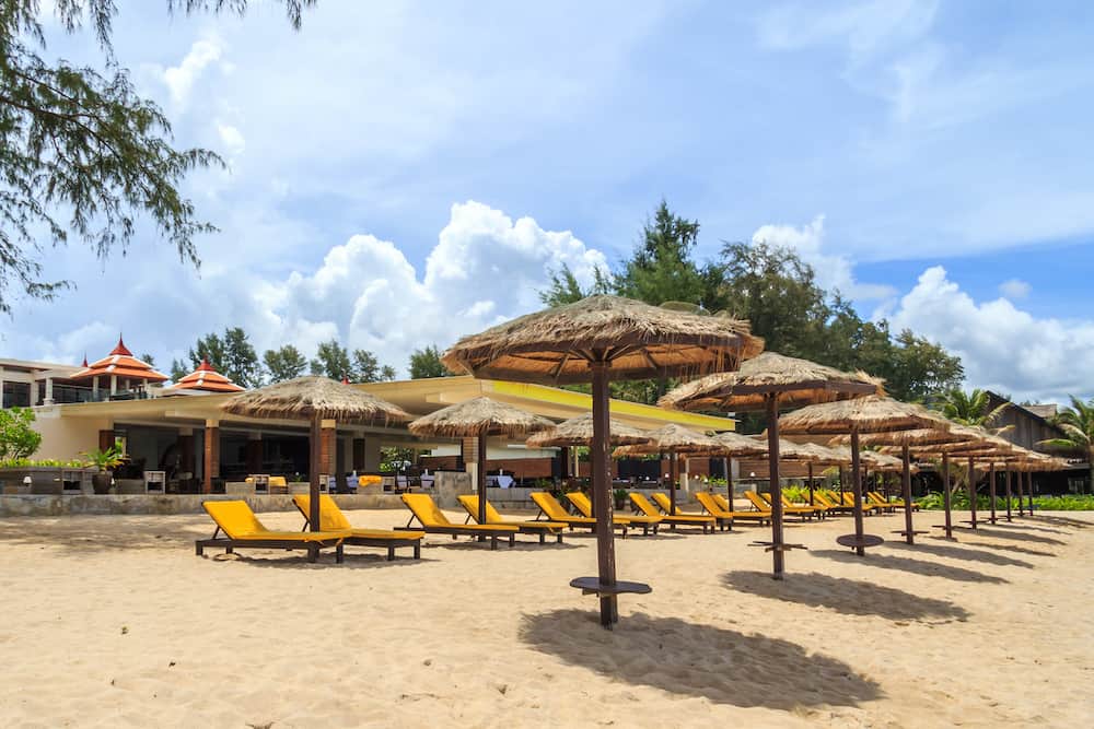 Row of beach parasols and chairs on Bang Tao beach, Phuket, Thailand